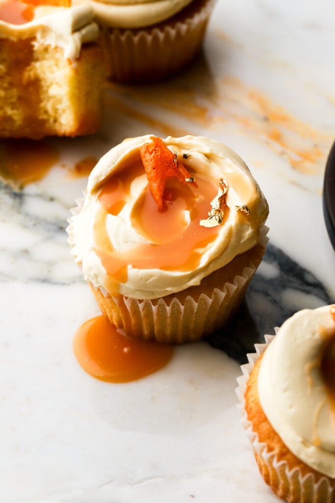 orange cupcakes topped with orange caramel sauce