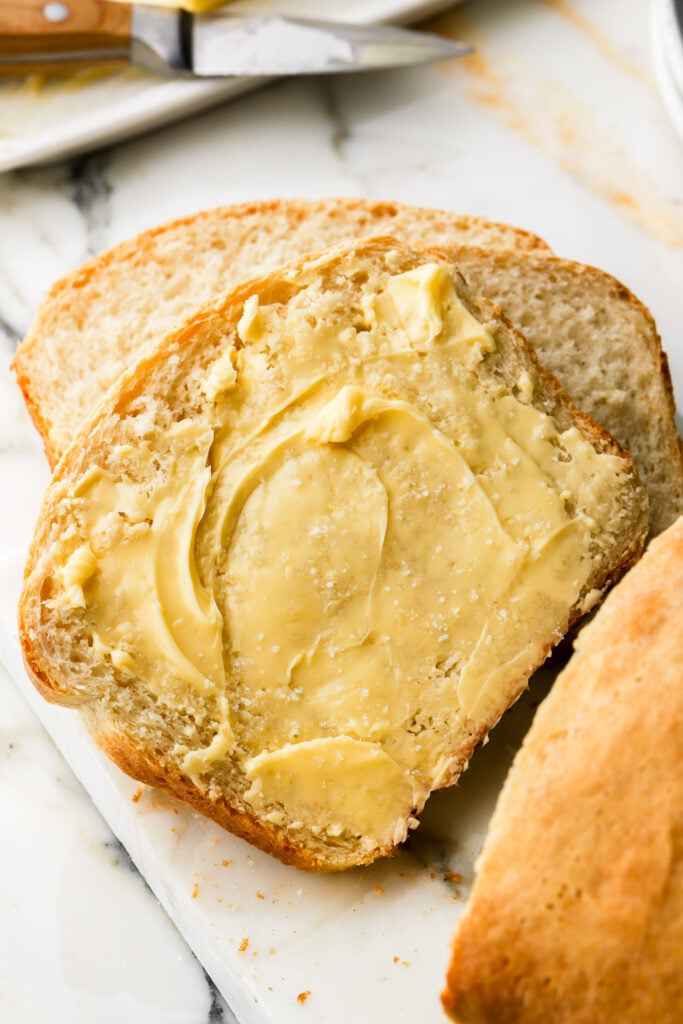 slice of bread with butter spread on it
