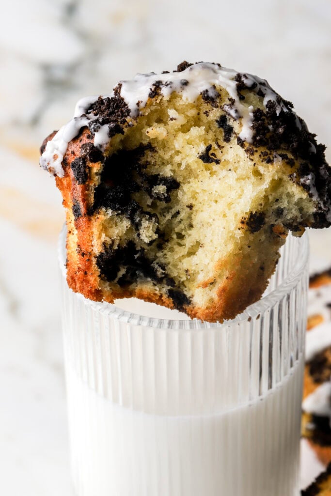 oreo muffin sitting on top of a cup of milk
