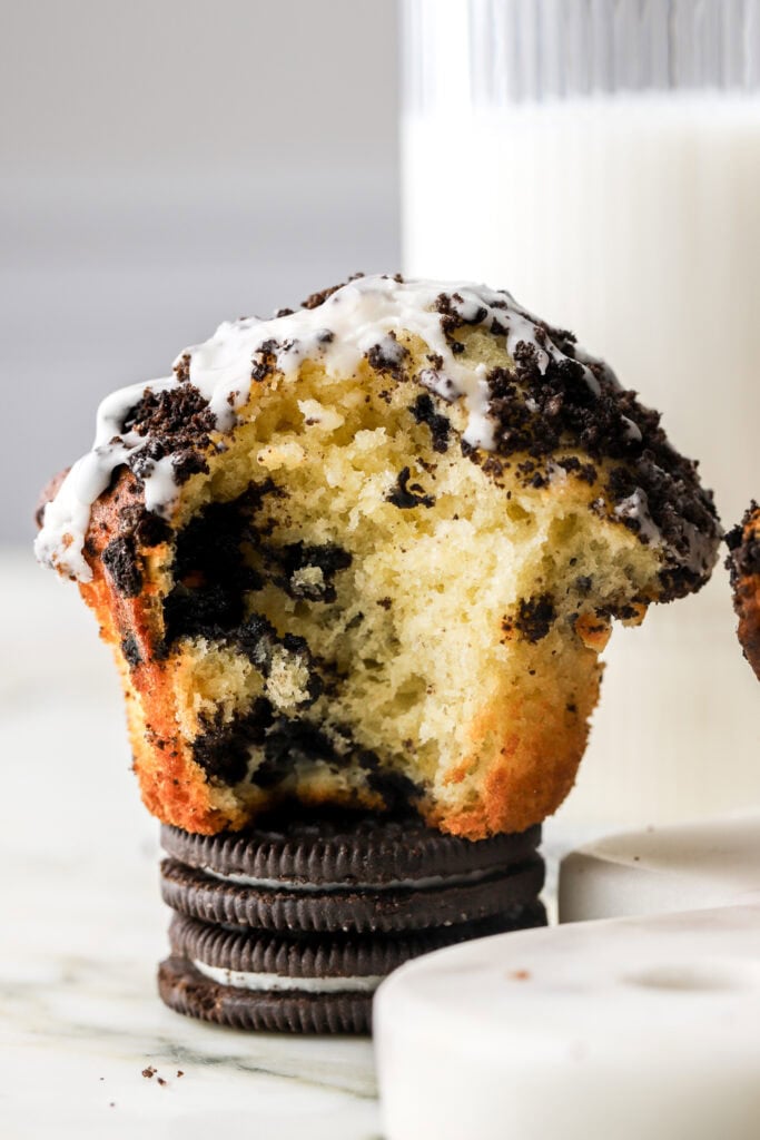oreo muffin sitting on an oreo with milk in the background