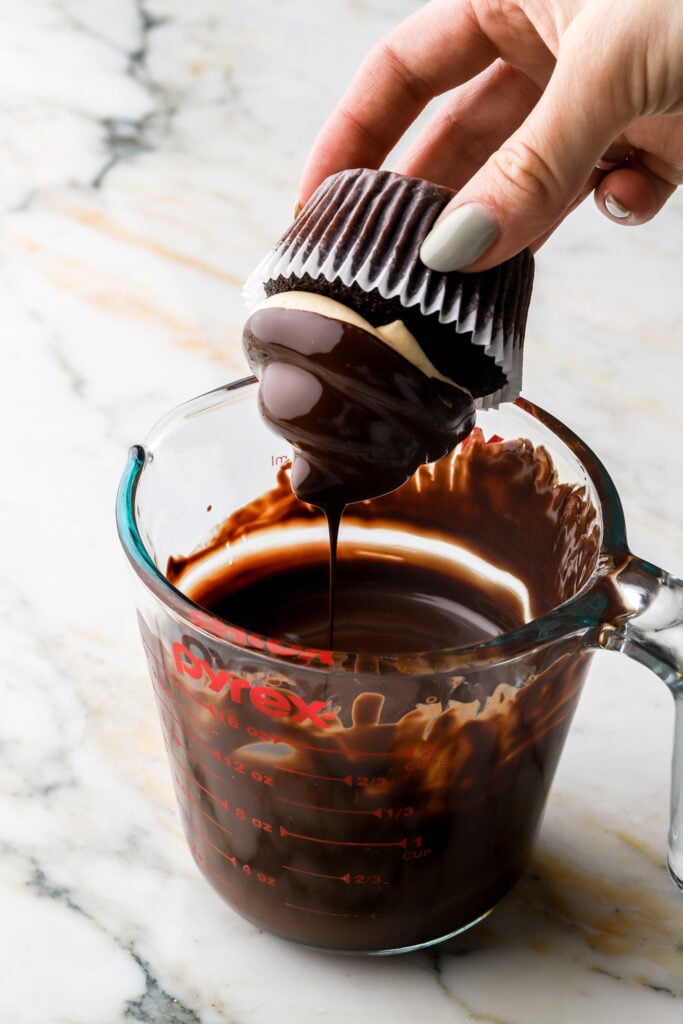 dip the cupcakes into the melted chocolate