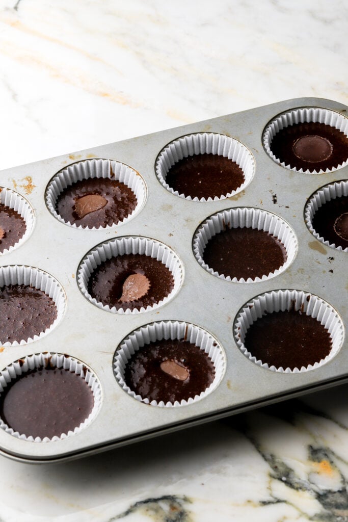 peanut butter cups pressed into the cupcakes (make sure to press it into the batter).