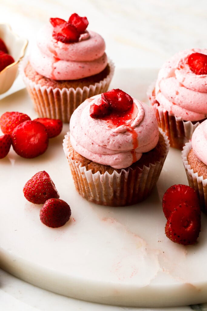 strawberry cupcakes topped with fresh strawberry slices