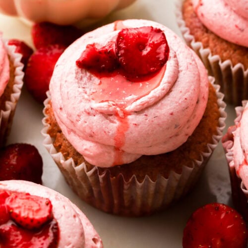 close up of strawberry cupcakes topped with strawberry slices