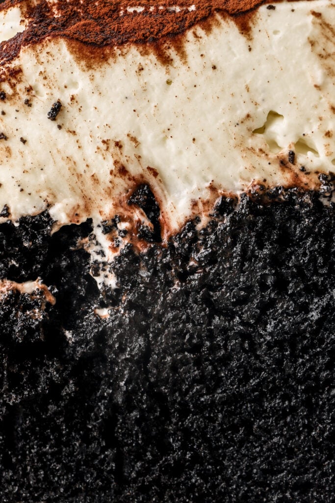 close up of black cake with mascarpone cream