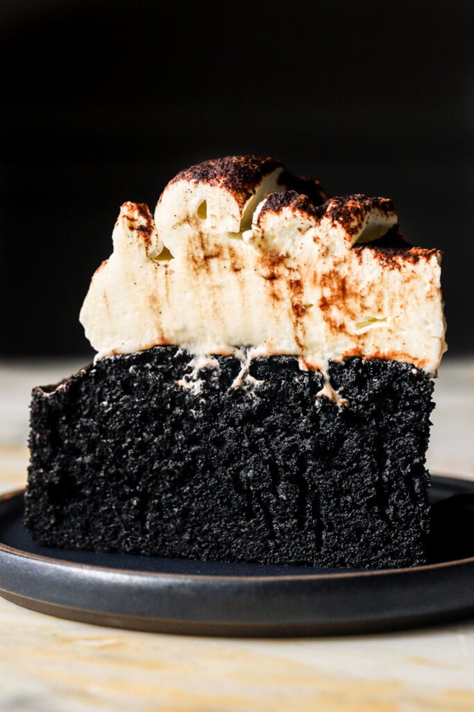 slice of black cocoa cake on a plate