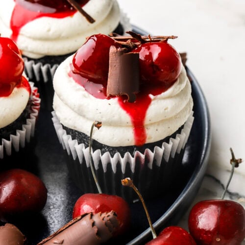 black forest cupcakes on a plate with cherries