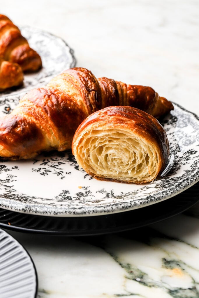 croissant cut in half to show inside, on a plate