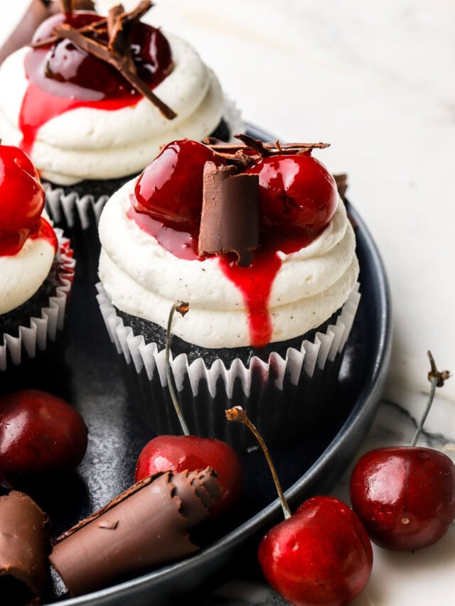 black forest cupcakes on a plate with cherries