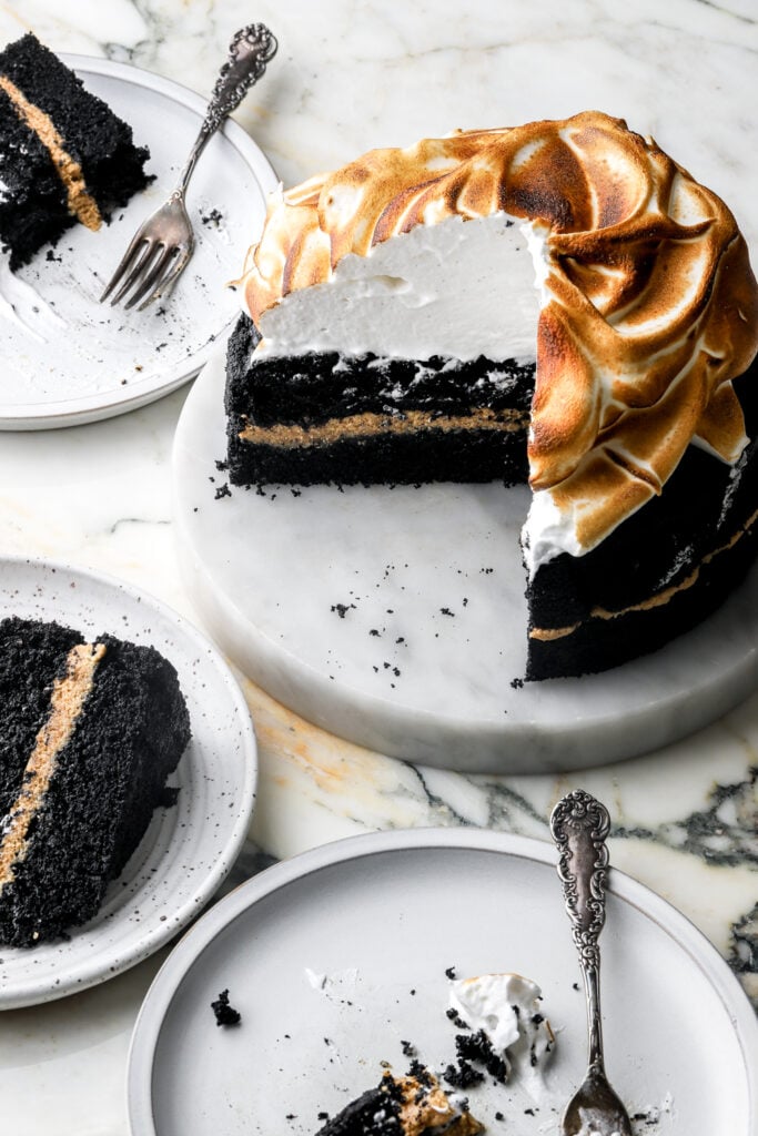 chocolate s'mores cake with slices and forks on a plate