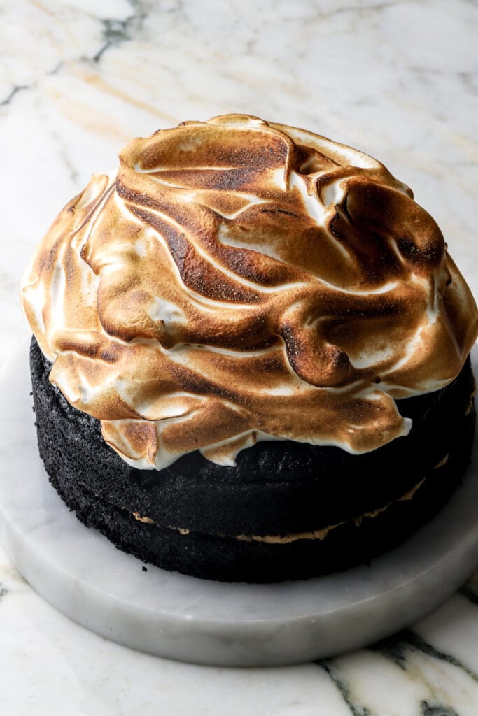 meringue spread on top of cake and toasted with a culinary torch