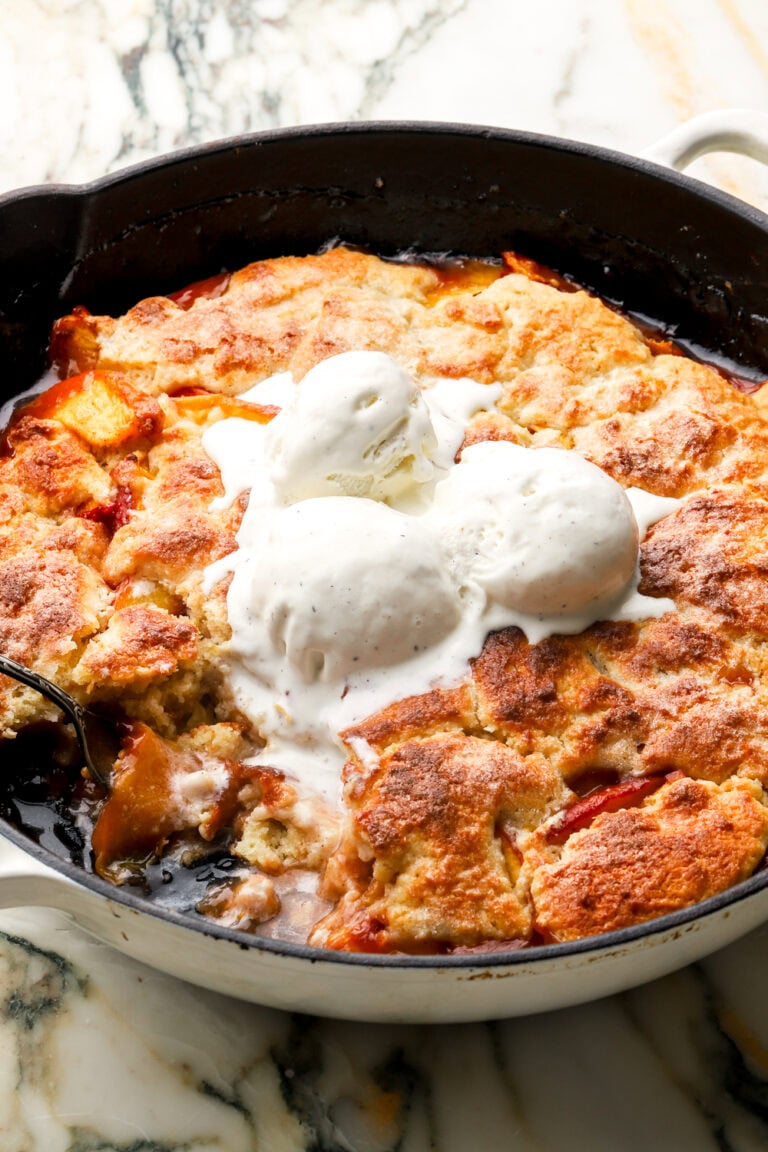 peach cobbler topped with ice cream