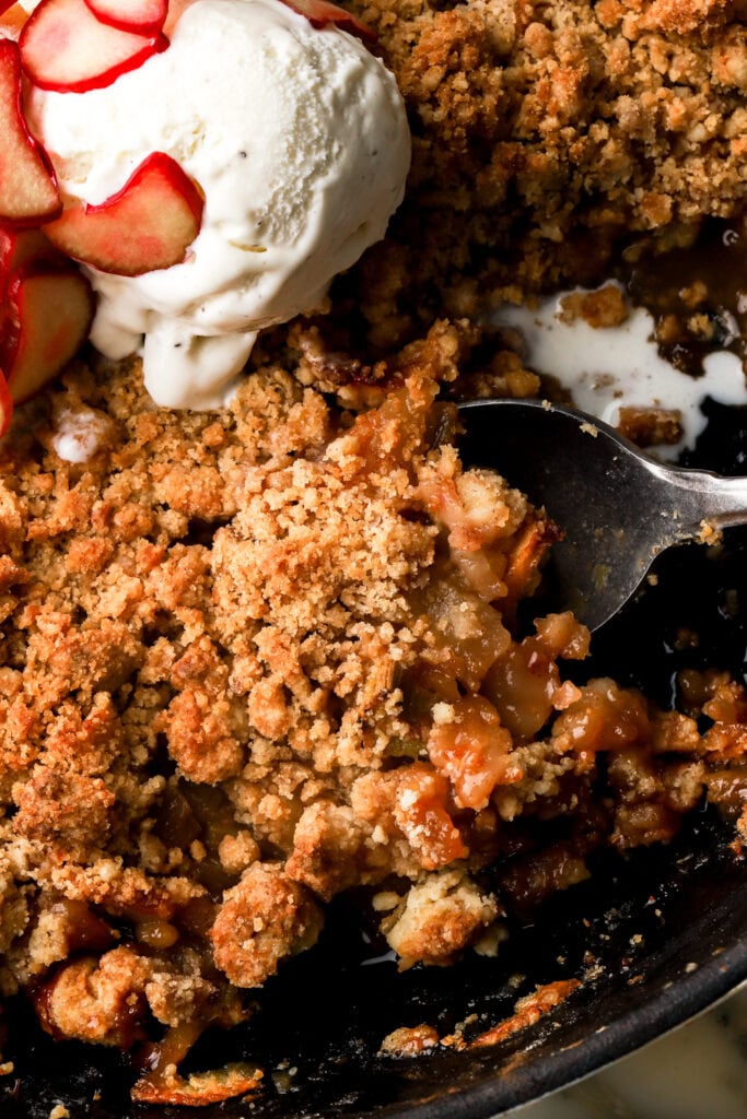 apple and rhubarb crisp topped with vanilla icde cream