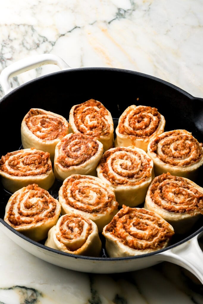 apple cinnamon rolls rolled up, sliced and placed in pan