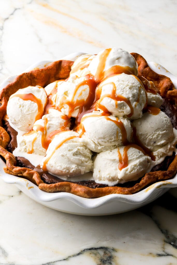 a whole tub of vanilla ice cream scooped on the pie