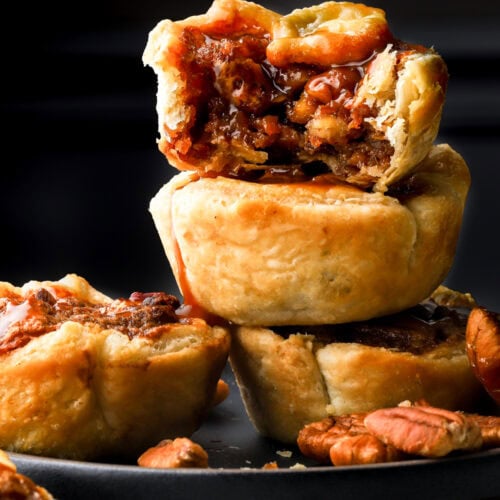 mini pecan pies stacked in a plate