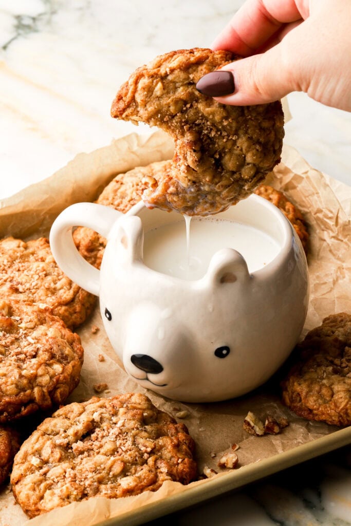 dipping pecan oatmeal cookie in milk