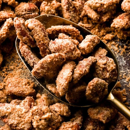 praline pecans getting scooped out of the pan