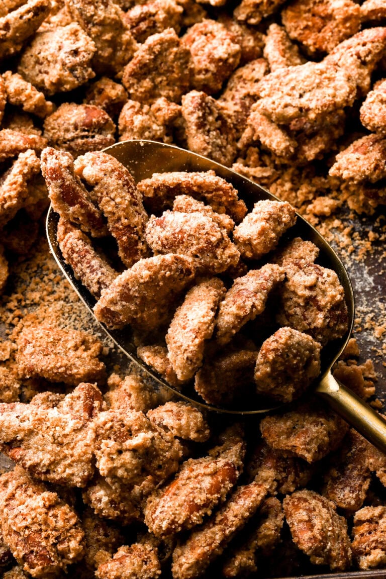 praline pecans getting scooped out of the pan