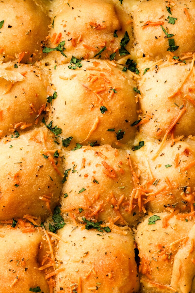 cheese bread rolls in pan topped with herbs