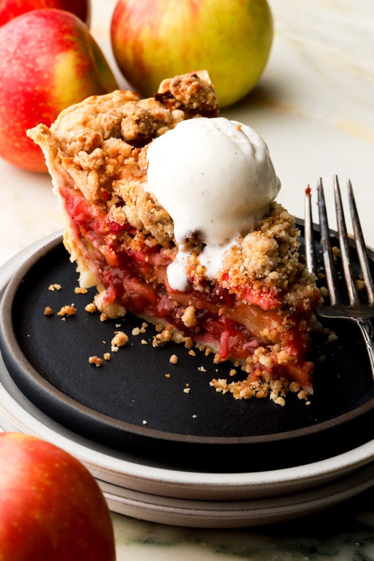 slice of apple cranberry pie with ice cream on top