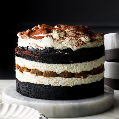 chocolate tiramisu cake with a plate and mugs next to it