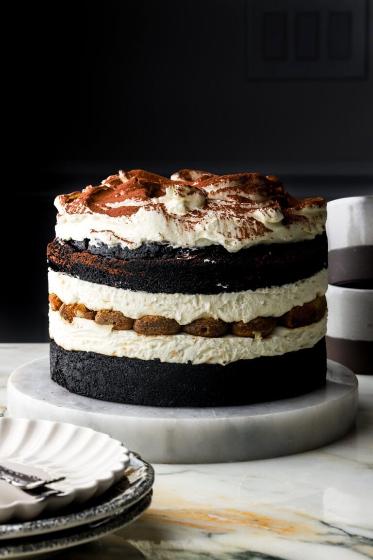 chocolate tiramisu cake with a plate and mugs next to it