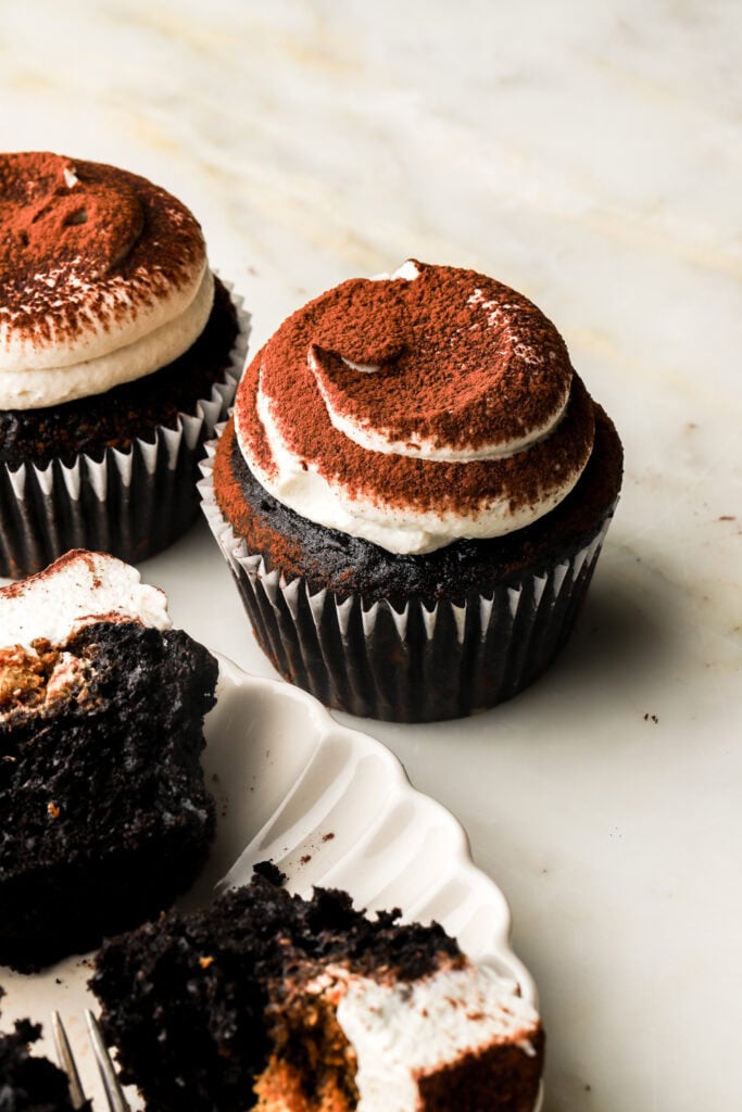 chocolate coffee cupcake frosted with mascarpone cream and dusted with cocoa powder