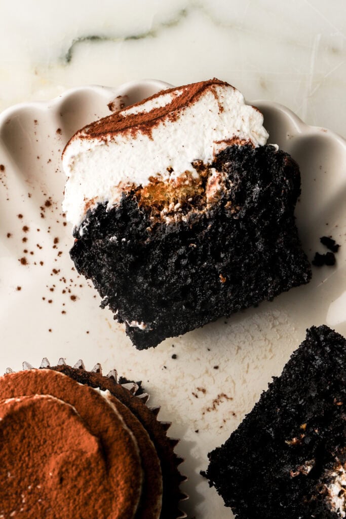 chocolate tiramisu cupcake sliced in half on a plate