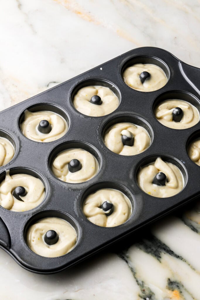 batter piped into mini donut pan