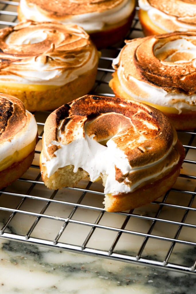 close up of a lemon donuts topped with lemon curd and toasted meringue