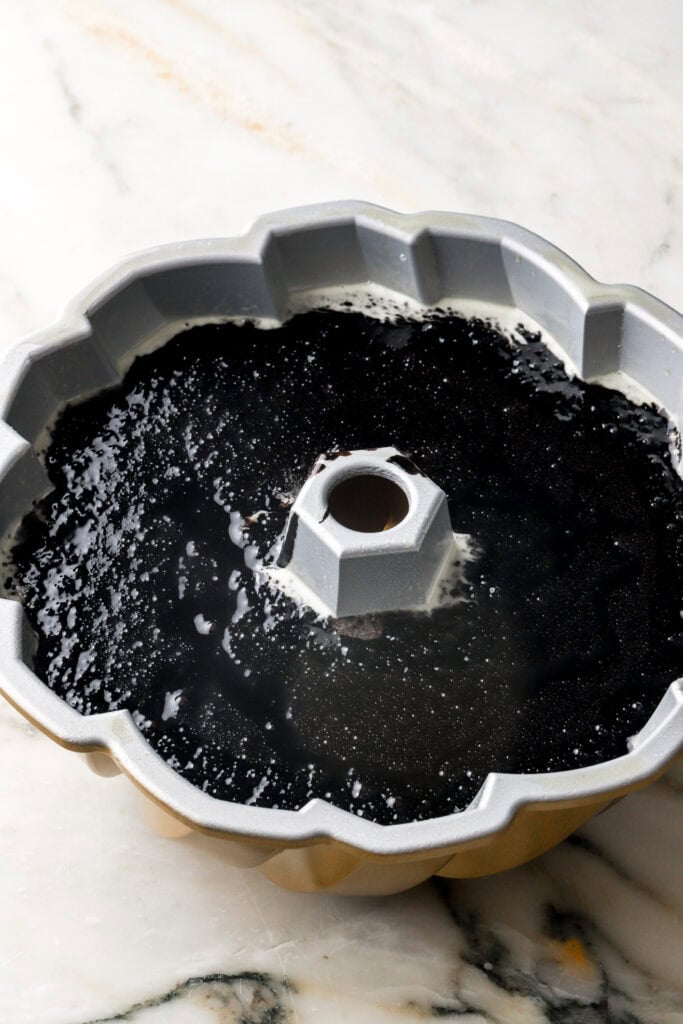 black cocoa cake batter in greased bundt pan