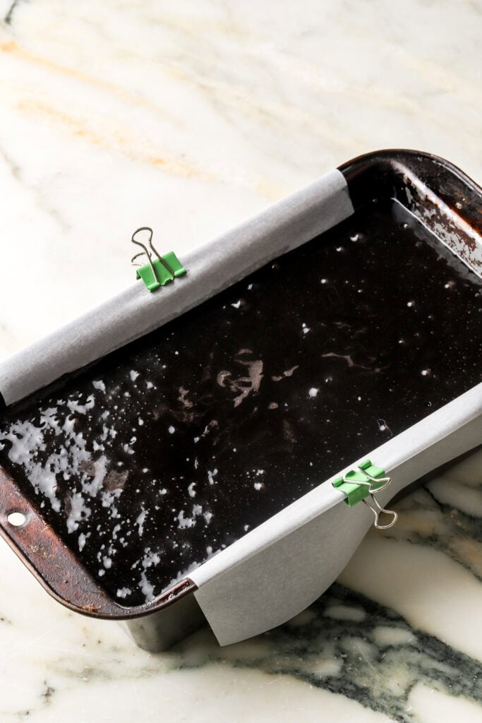 black cocoa cake batter poured into prepared loaf pan
