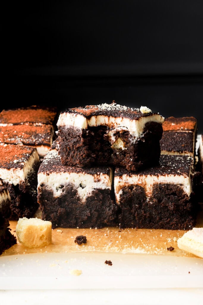 tiramisu brownies sliced and stacked with a bite taken out