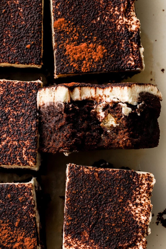 close up of tiramisu brownies sliced and a bite taken out