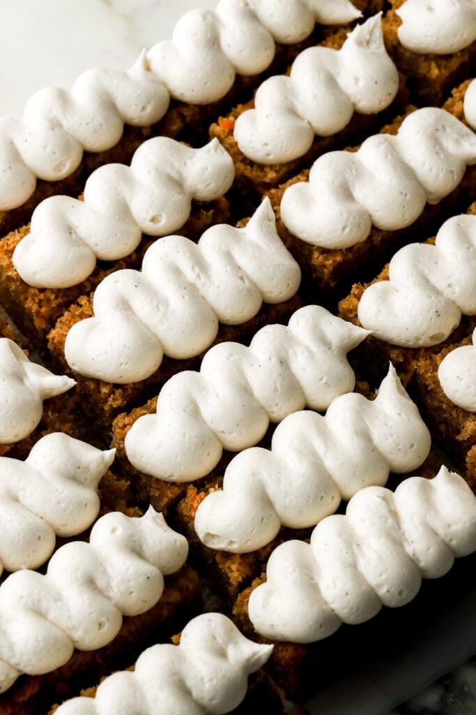carrot cake slices frosted with piped cream cheese frosting