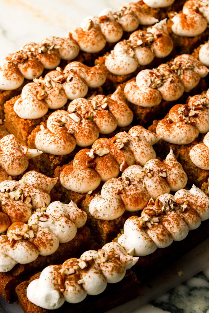 carrot cake slices topped with cinnamon and nuts