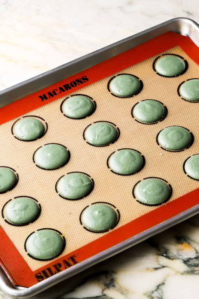 pistachio macaron batter piped