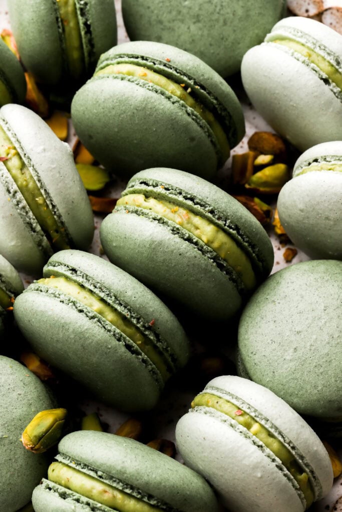 close up of pistachio macarons with pistachio buttercream
