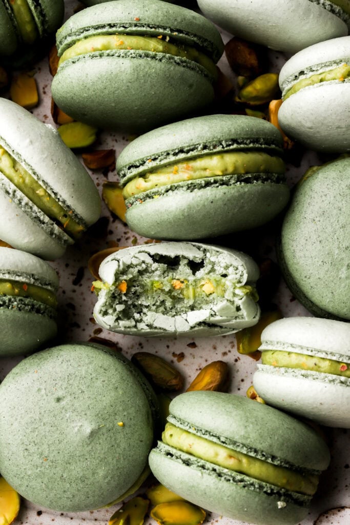 close up of pistachio macarons with a bite taken out
