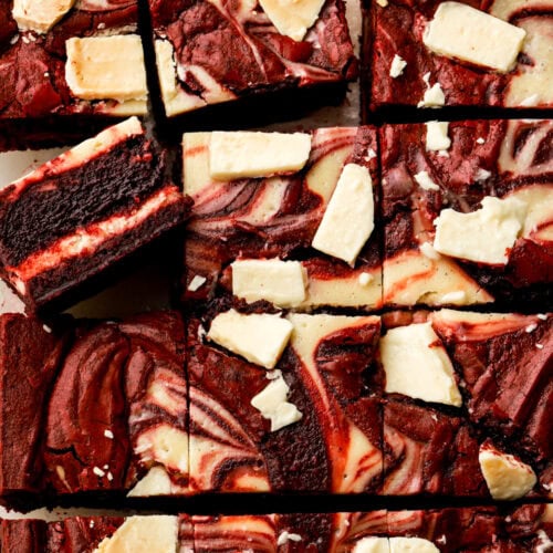 Red velvet cheesecake brownies sliced and showing the inside