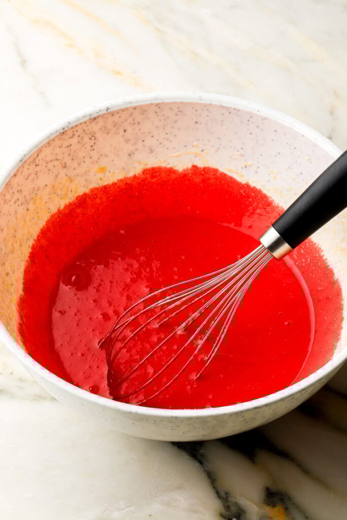 red food coloring and vinegar whisked into eggs