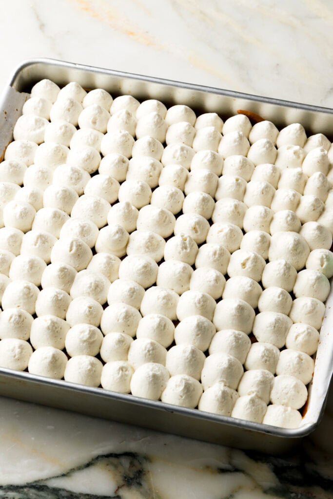 mascarpone cream piped on top of cake