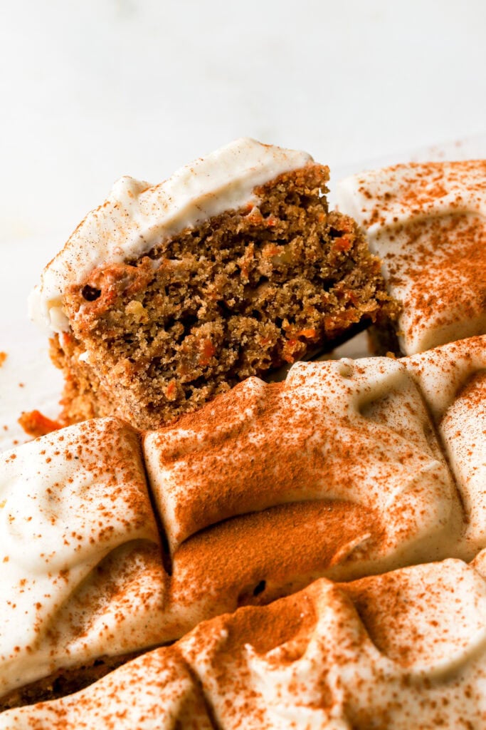 carrot cake cookie bars sliced and frosted with cream cheese frosting