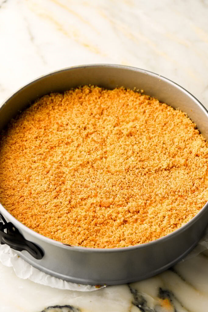 crushed crushed vanilla wafers on top of half of the cheesecake batter