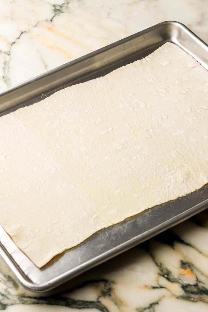 puff pastry rolled out on cookie sheet