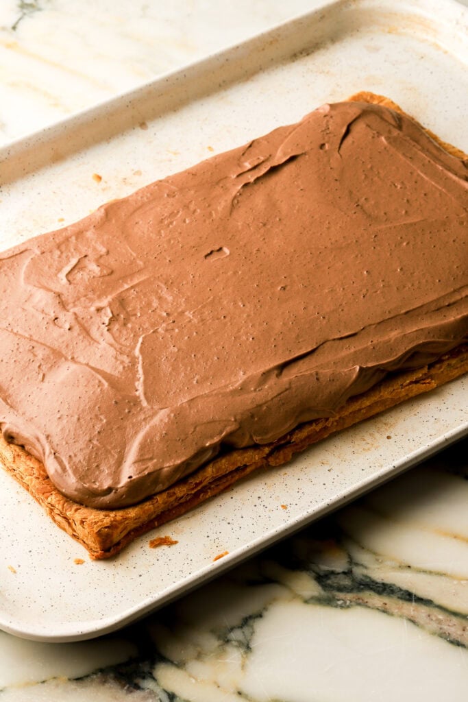 chocolate cream spread on top of bottom layer of puff pastry