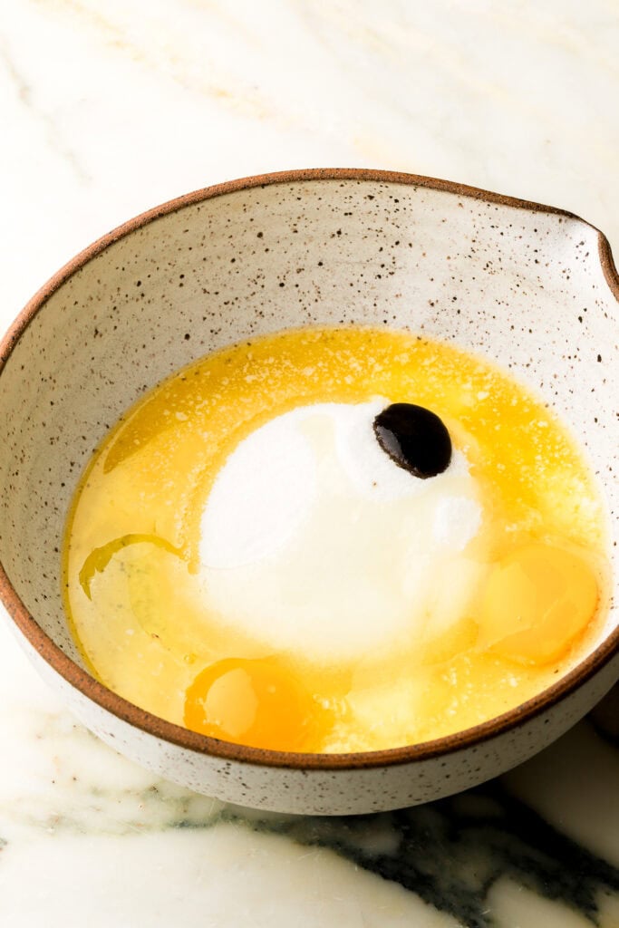 melted butter, sugar, eggs and vanilla in a bowl