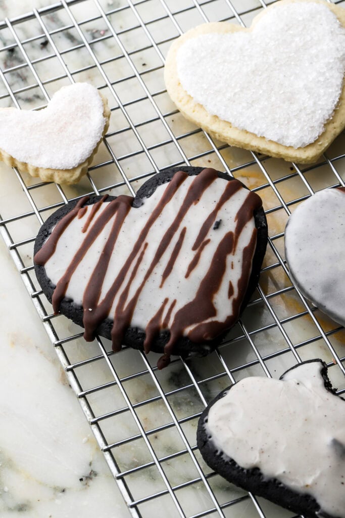 Black Cocoa Sugar Cookies cut into hearts and frosted with white icing