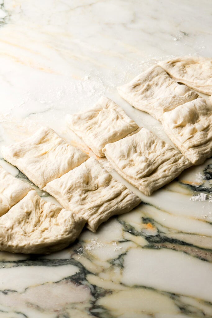 dough sliced in half and then into 10 squares